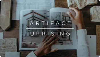 Artifact Uprising logo over an image of a person looking at a book with interior design photography