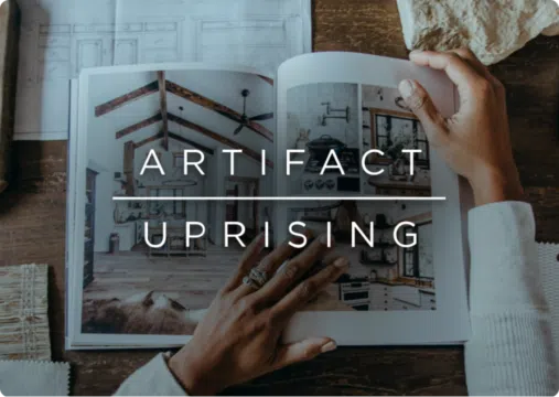 Artifact Uprising logo over an image of a person looking at a book with interior design photography