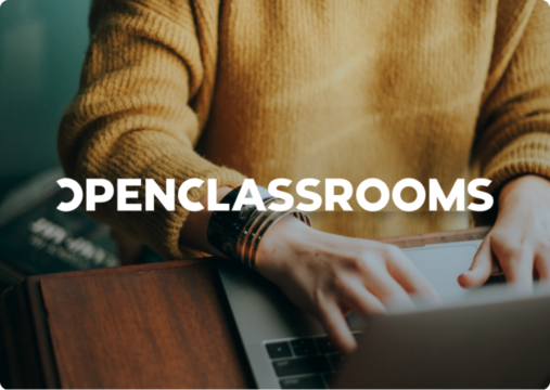 Open Classrooms logo over a person typing on a laptop