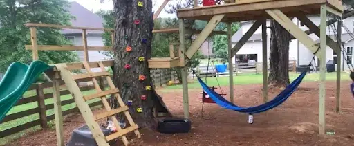 A backyard playground by a tree