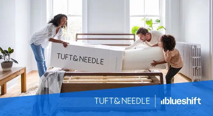 Tuft & Needle and Blueshift logos under an image of a family removing the contents from a box labeled "Tuft & Needle"