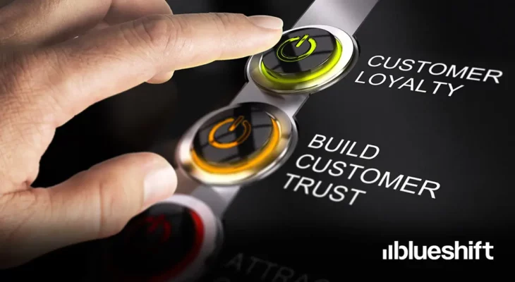 A hand hovering over buttons labeled "customer loyalty" and "build customer trust"