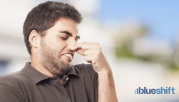 A man plugging his nose in disgust