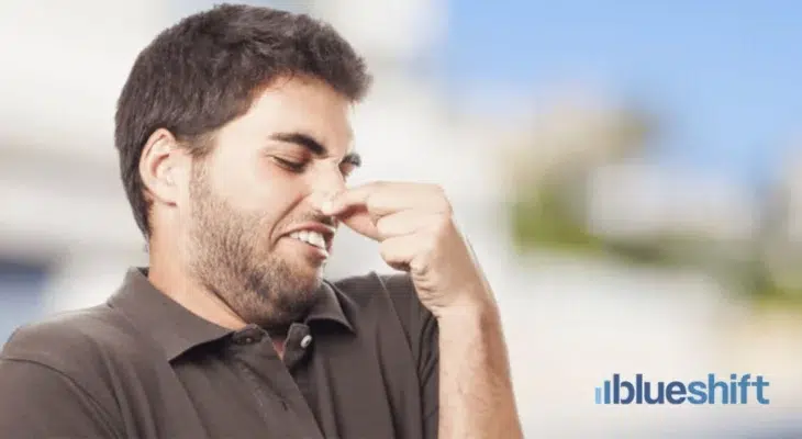 A man plugging his nose in disgust
