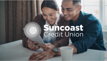 man and woman are smiling and looking at a tablet together with an "ent credit union" logo laid overtop