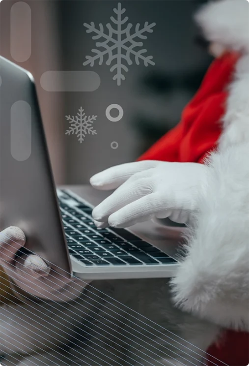 santa claus' hands typing on a laptop